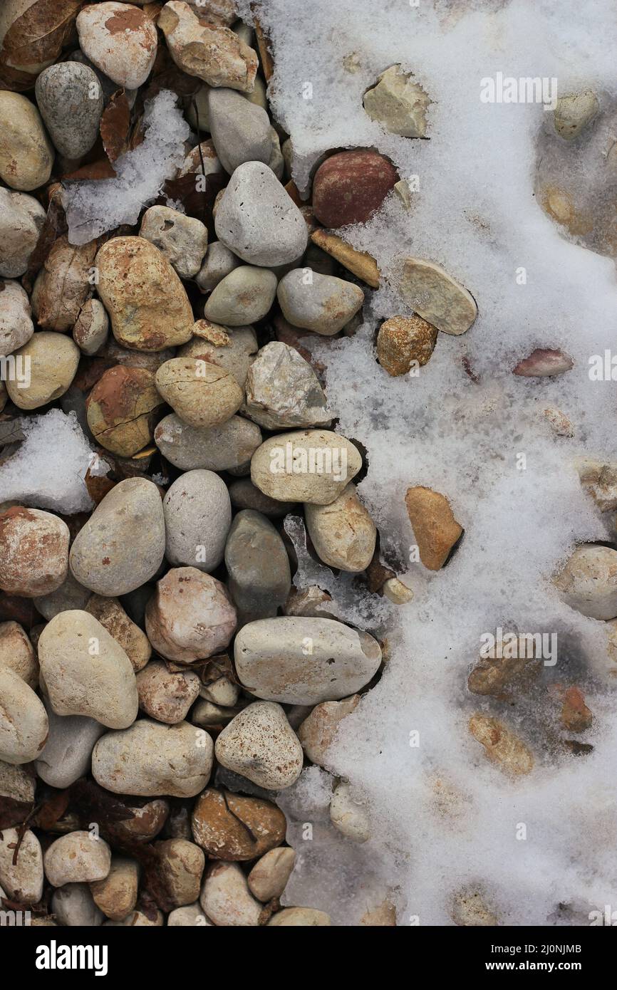 Layed With Rocks Natural rocks and stones laying on the ground covered with fresh white ...