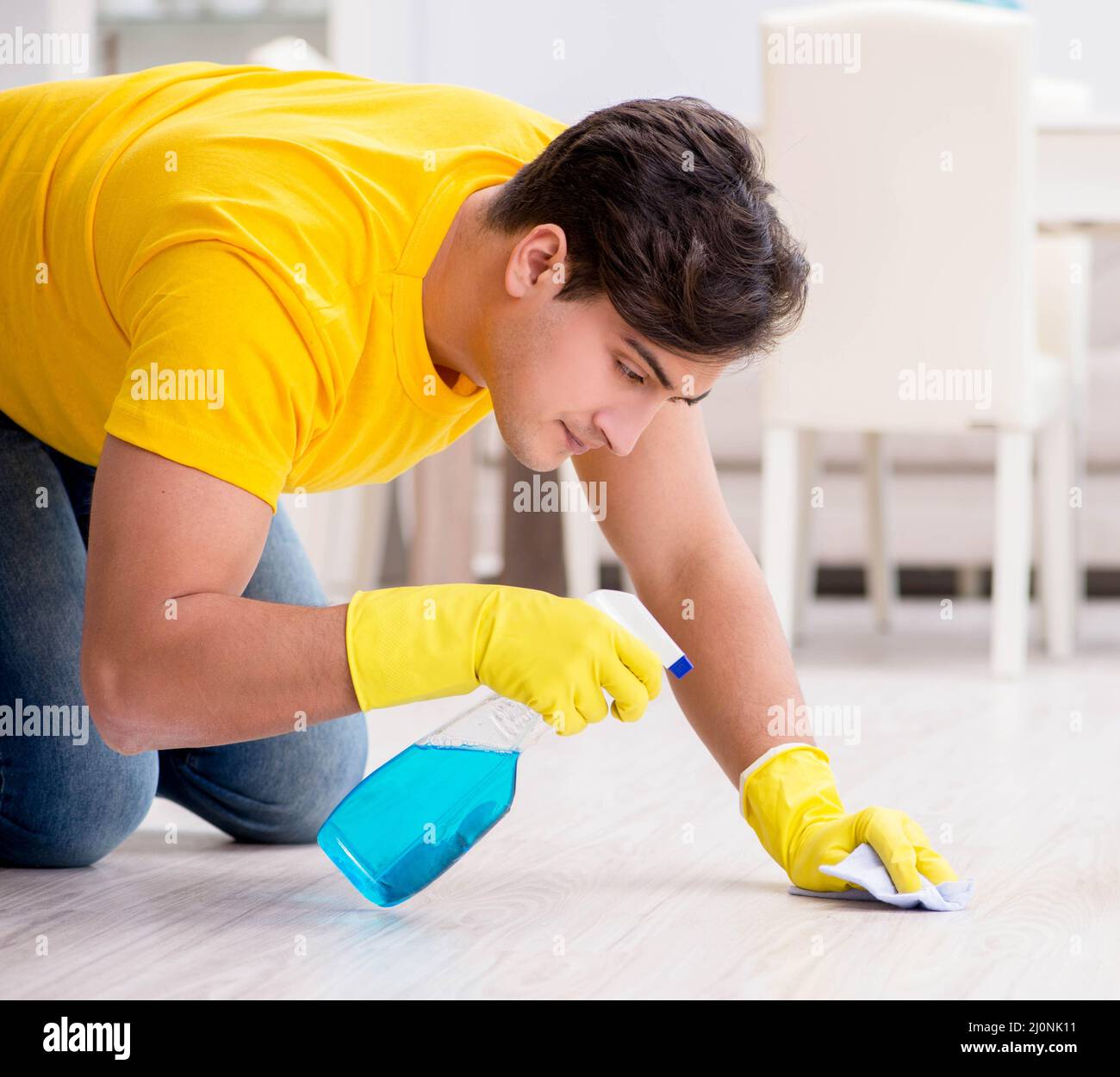 Man cleaning the house helping his wife Stock Photo