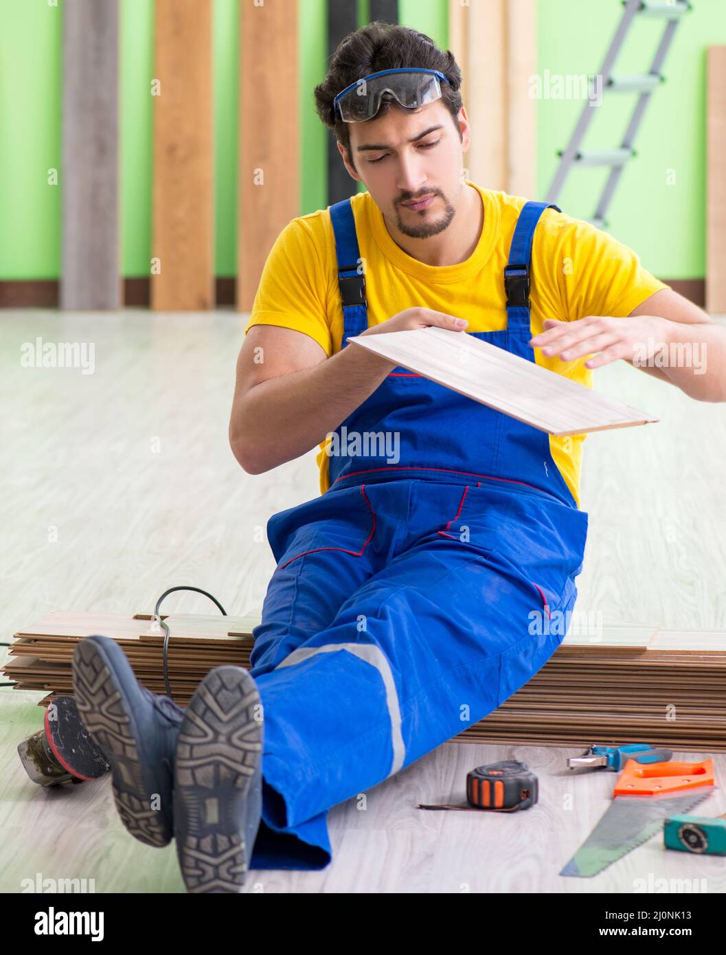 Professional contractor laying flooring at home Stock Photo