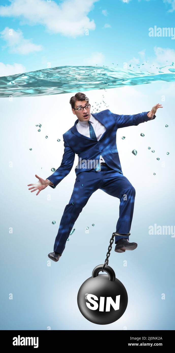 Businessman drowning under the burden of sin and guilt Stock Photo
