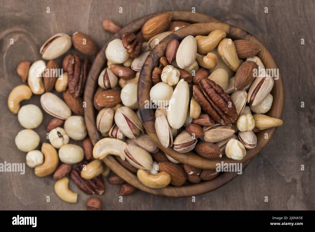 Pile bowls filled with organic nuts top view . High quality and