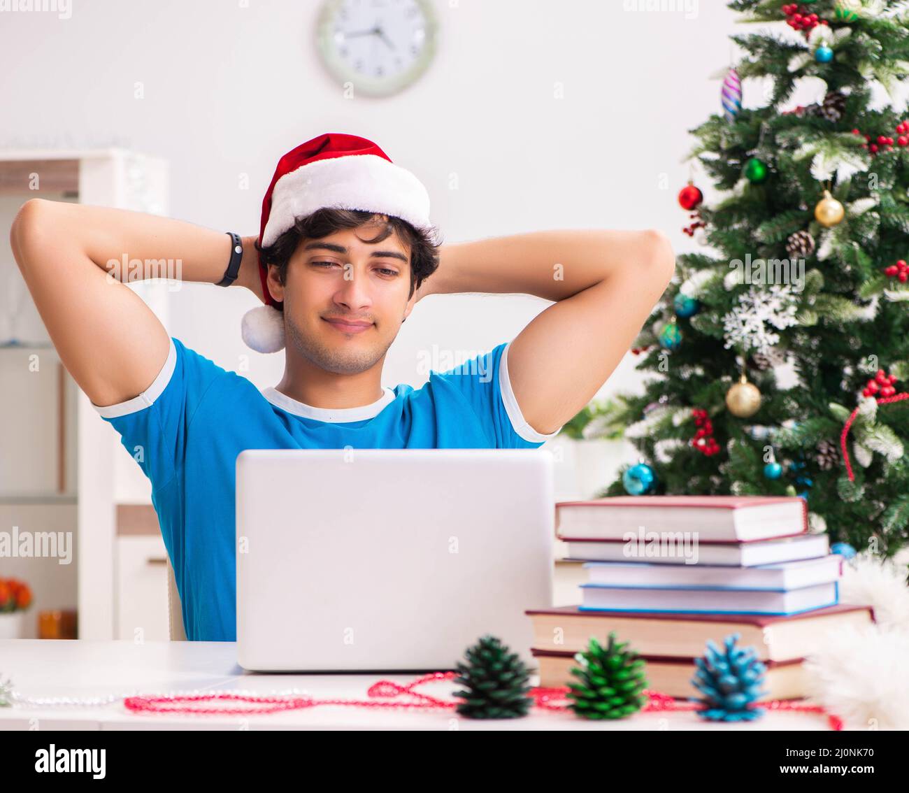 Young student with book at Christmas eve Stock Photo