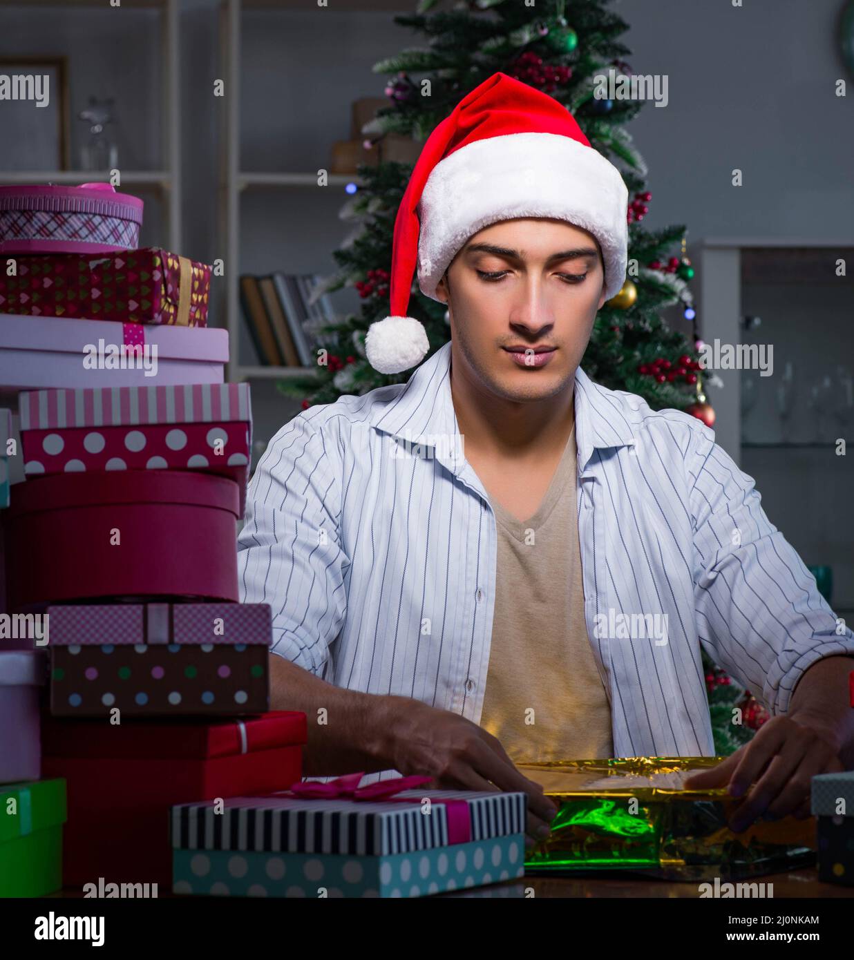 Man with many christmas gifts in boxes Stock Photo