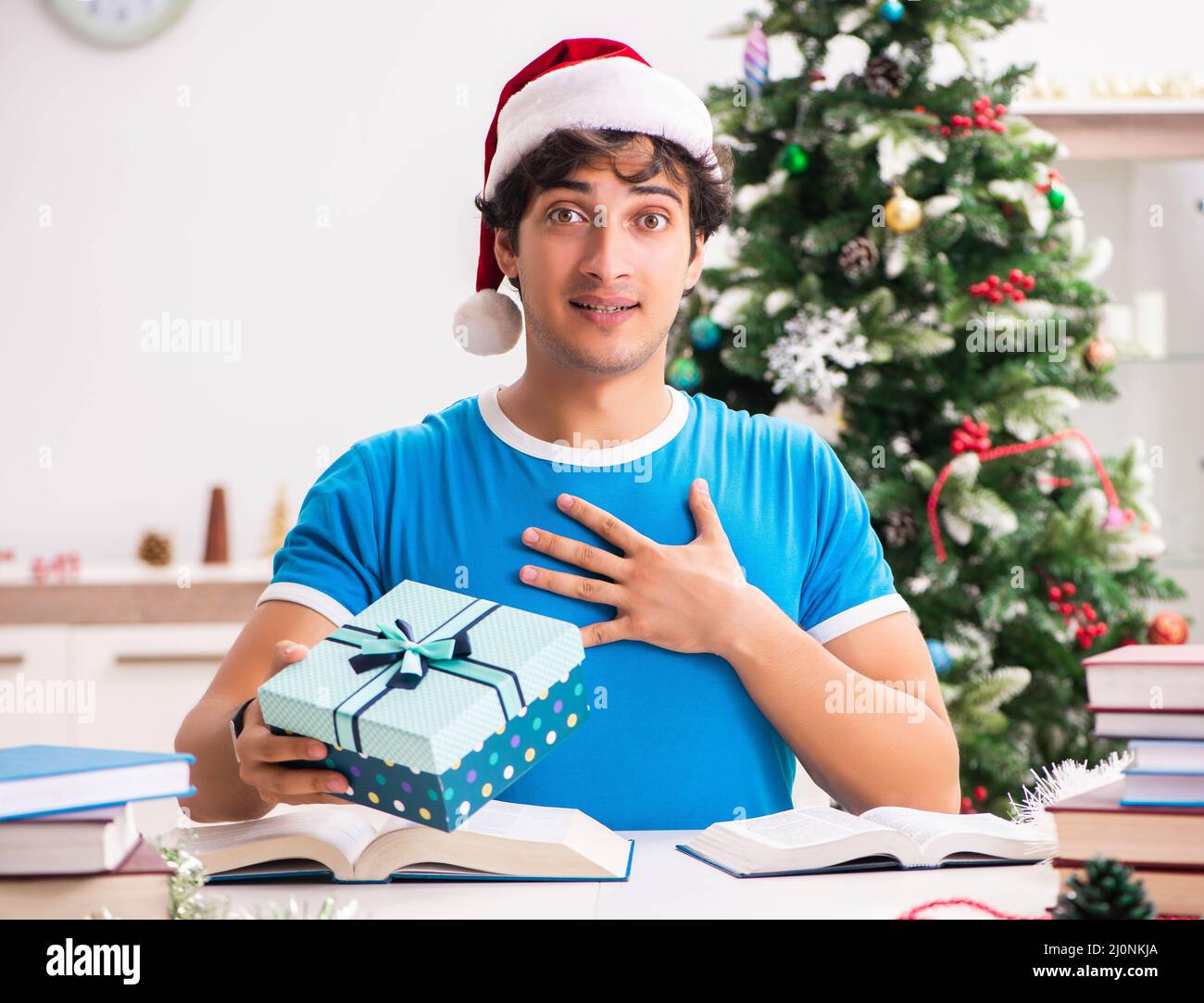 Young student with book at Christmas eve Stock Photo