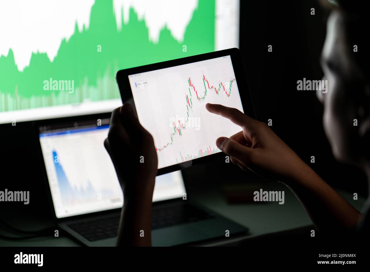 Crypto trader investor analyst looking at computer screen analyzing financial graph data on pc Stock Photo