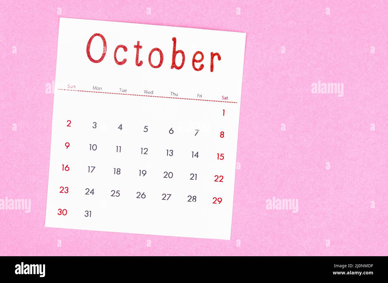 The October 2022 calendar on pink background with empty space. Stock Photo