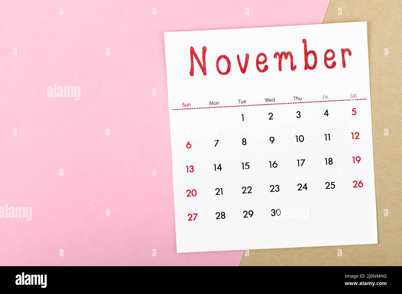 The November 2022 calendar on pink background with empty space. Stock Photo