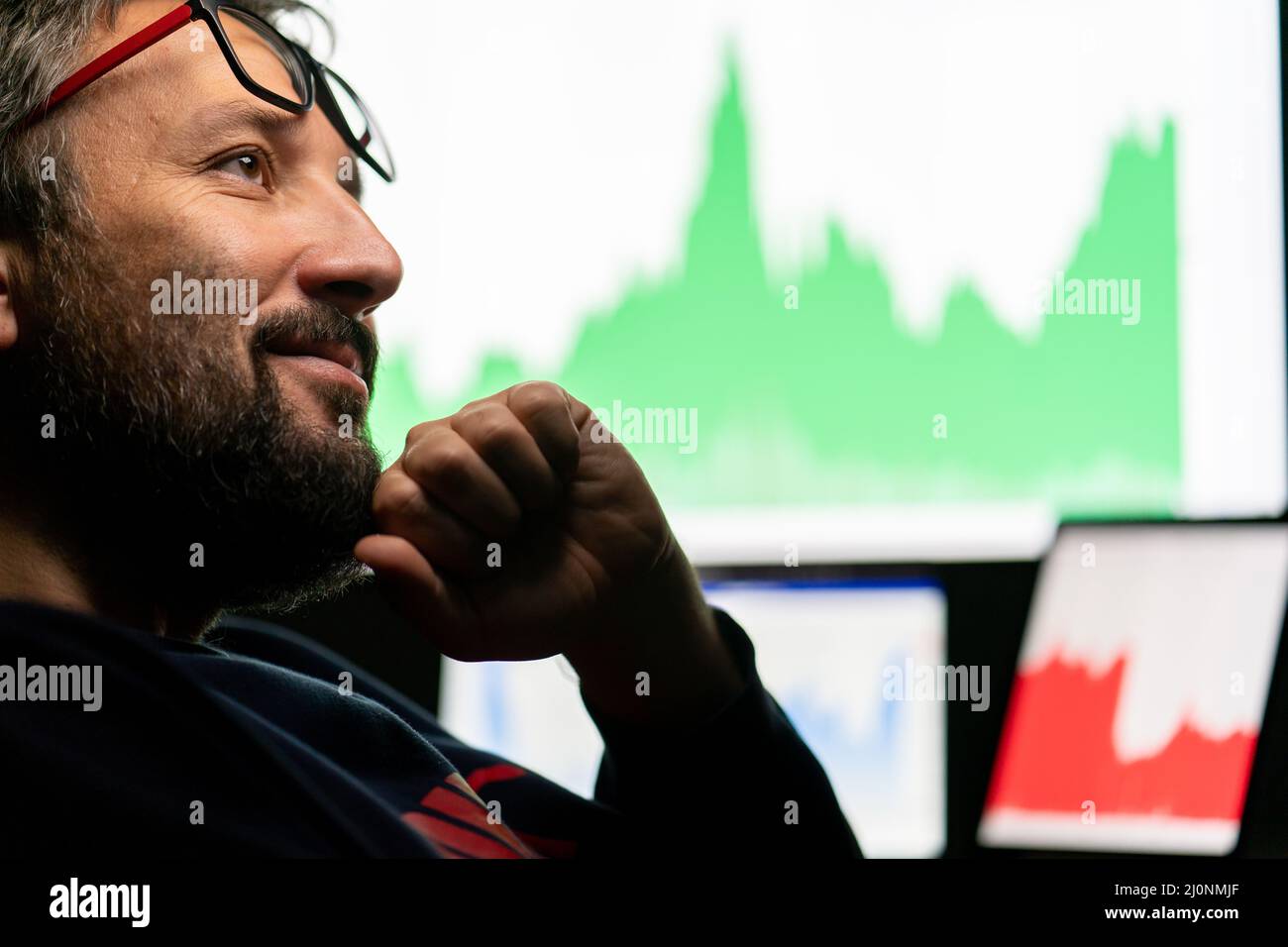 Crypto trader investor analyst looking at computer screen analyzing financial graph data on pc Stock Photo