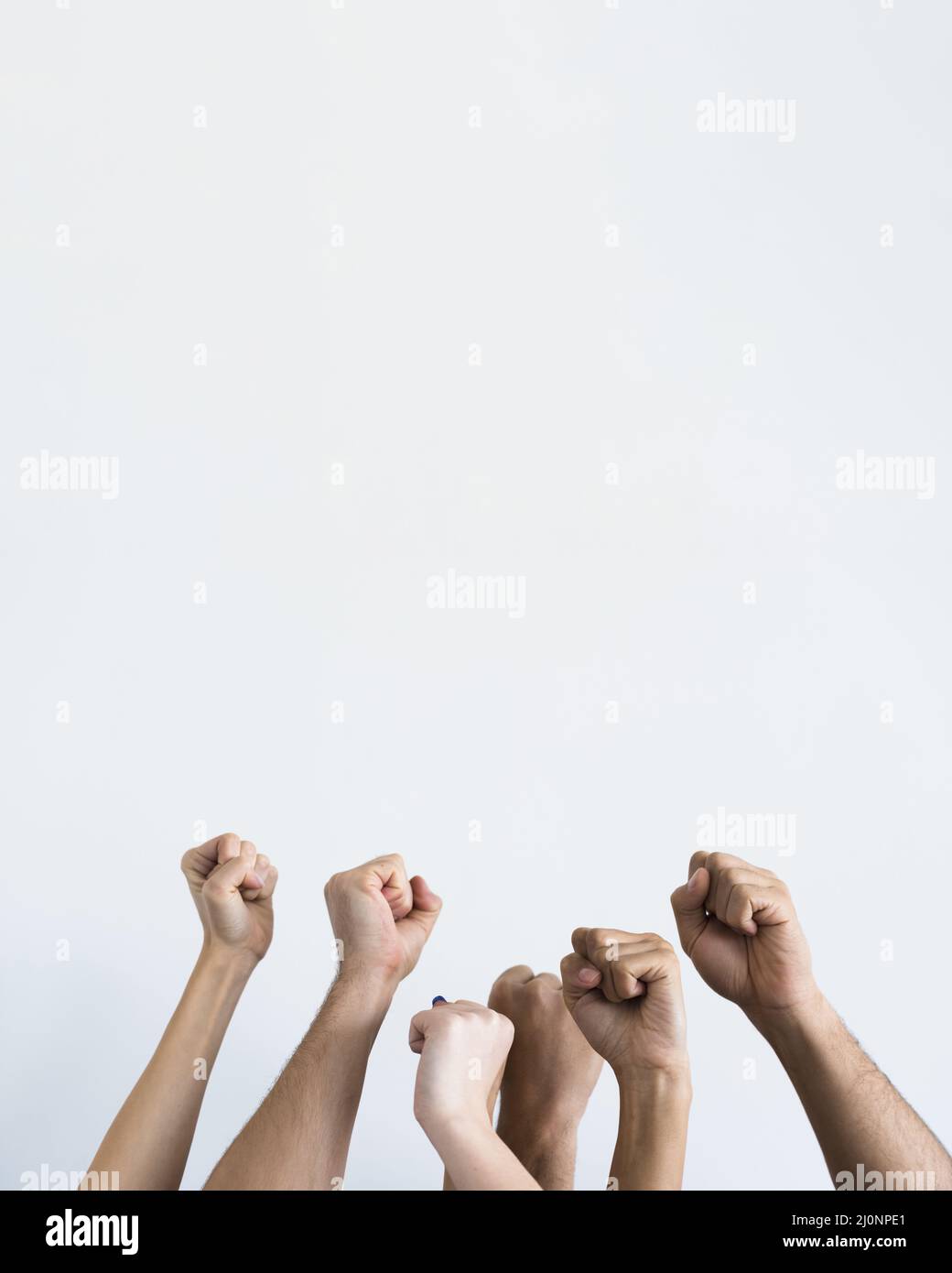 People holding fists up together . High quality and resolution beautiful photo concept Stock Photo