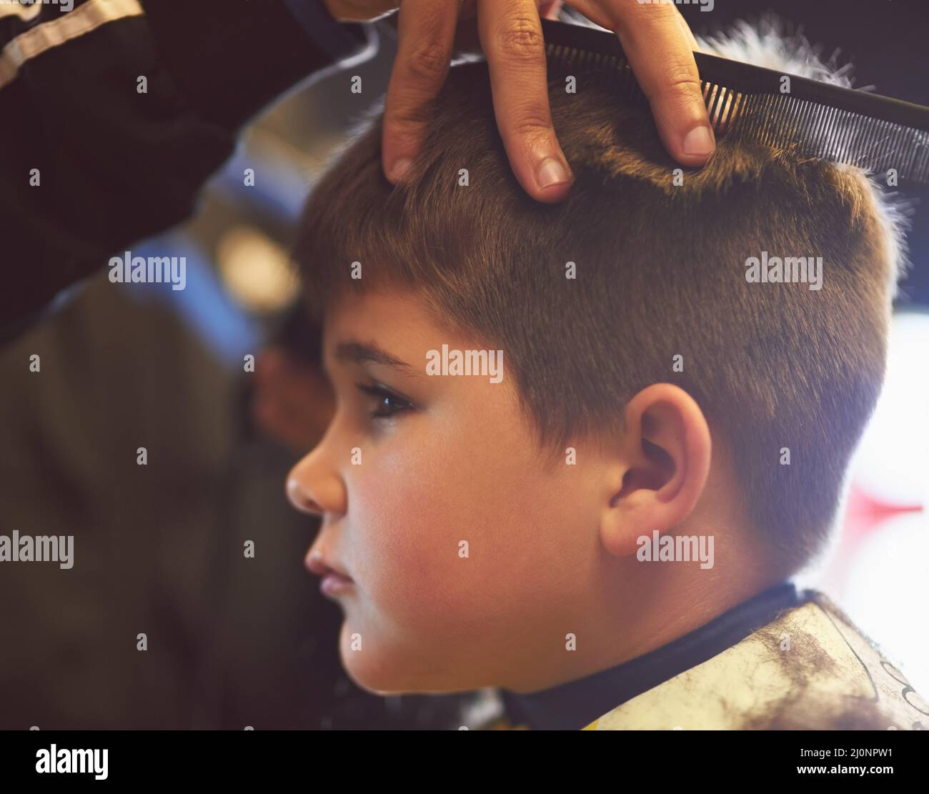 Just a bit of the top please. Closeup shot of a young boy getting a haircut at a barber shop. Stock Photo