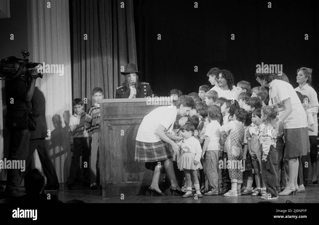 Bucharest, Romania, 1990. American artist Michael Jackson with a group of children from a local orphanage. Stock Photo