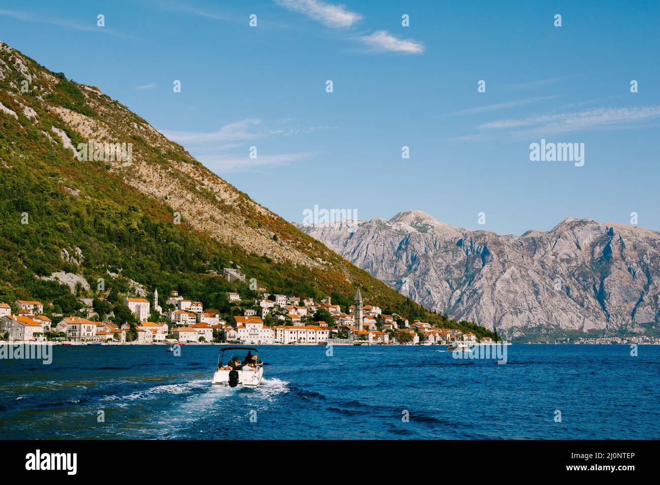 Motor boat sails to the coast of Perast. Montenegro. Back view Stock Photo