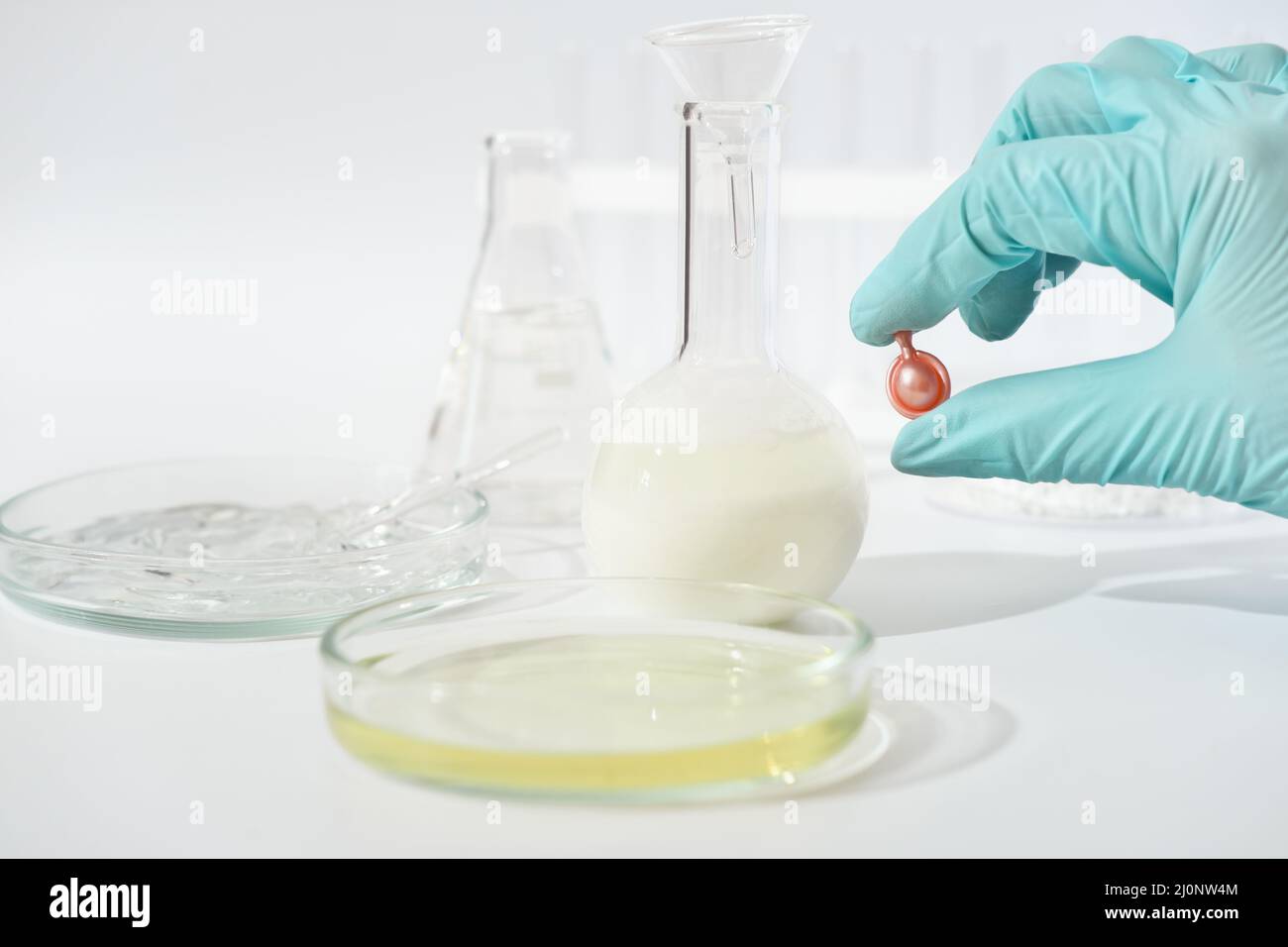 test of cosmetic product in capsules in the lab. hand in medical gloves