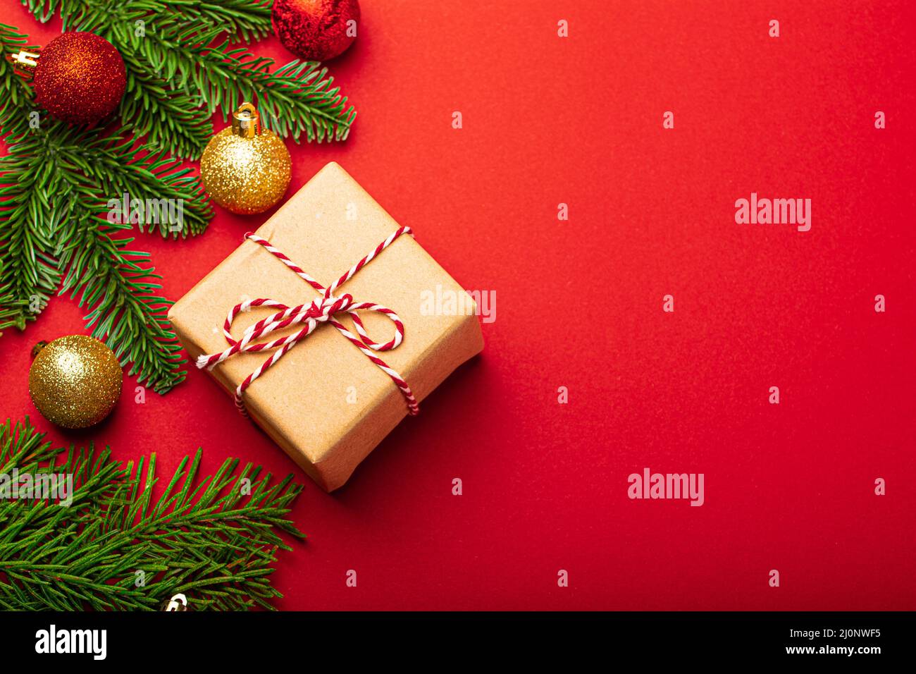 Christmas decorations, fir tree on red background copy space Stock Photo