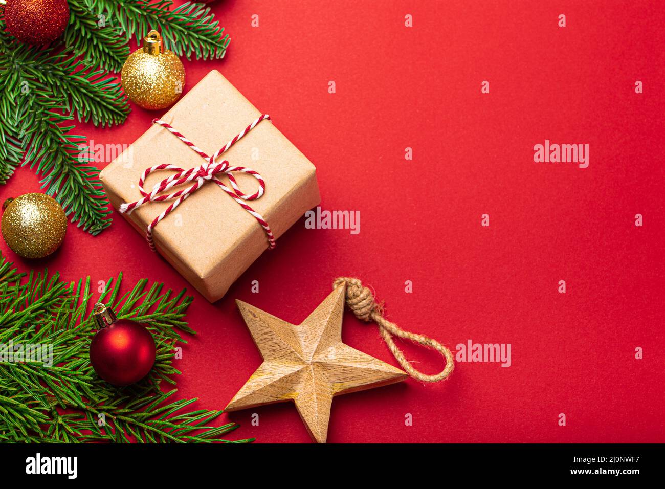 Christmas decorations, fir tree, present on red background copy space Stock Photo