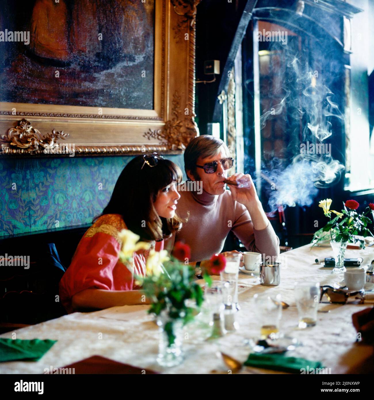 Vintage Netherlands 1970s, middle aged couple by lunch in luxury restaurant, man smoking a cigar, Marken, Northern Holland, Europe, Stock Photo