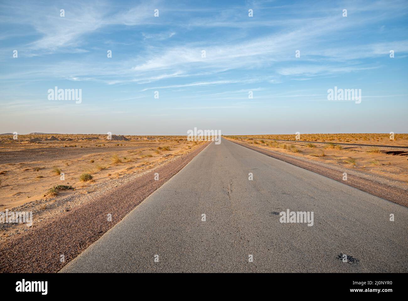 Paved road with no cars in the Sahara desert, Mauritania Stock Photo