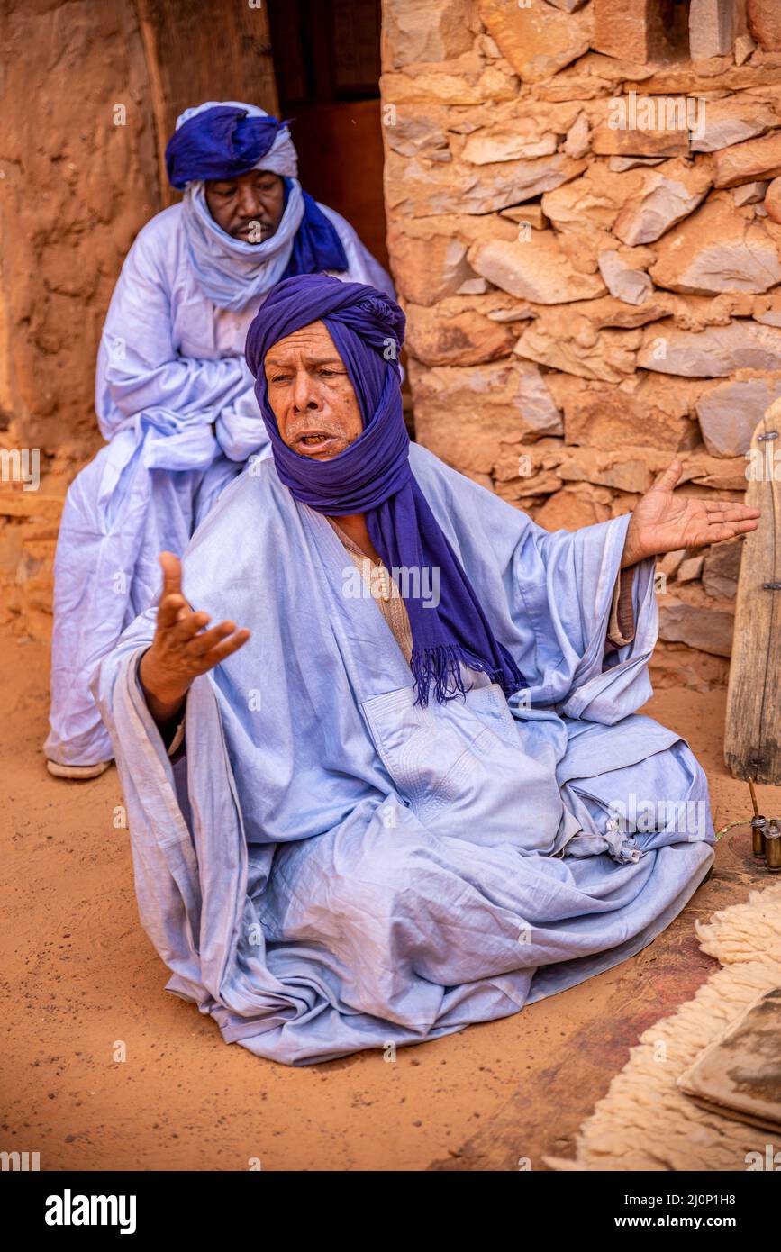 Two Mauritanian men with traditional blue boubou and turban at an antique library, Chinguetti, Mauritania Stock Photo