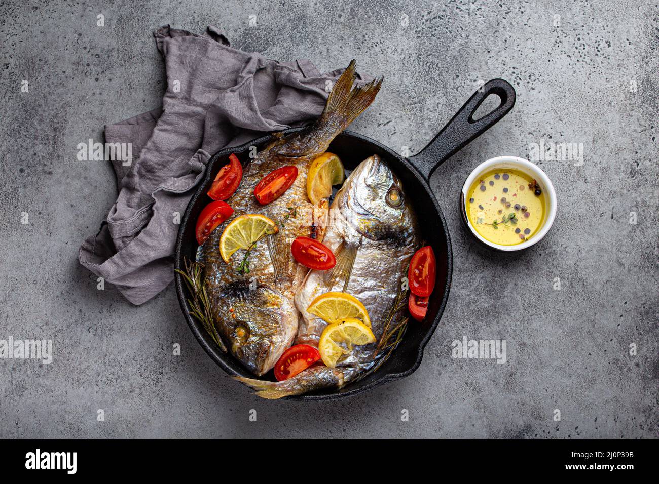 Grilled fish sea bream or dorado in cast iron skillet Stock Photo Alamy