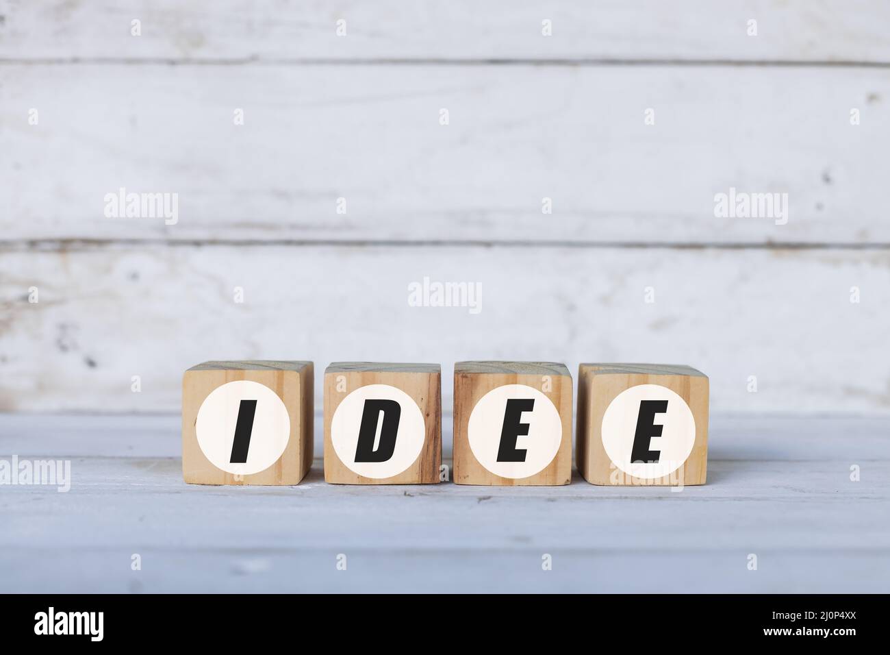 Idee concept written on wooden cubes or blocks, on white wooden background. Stock Photo