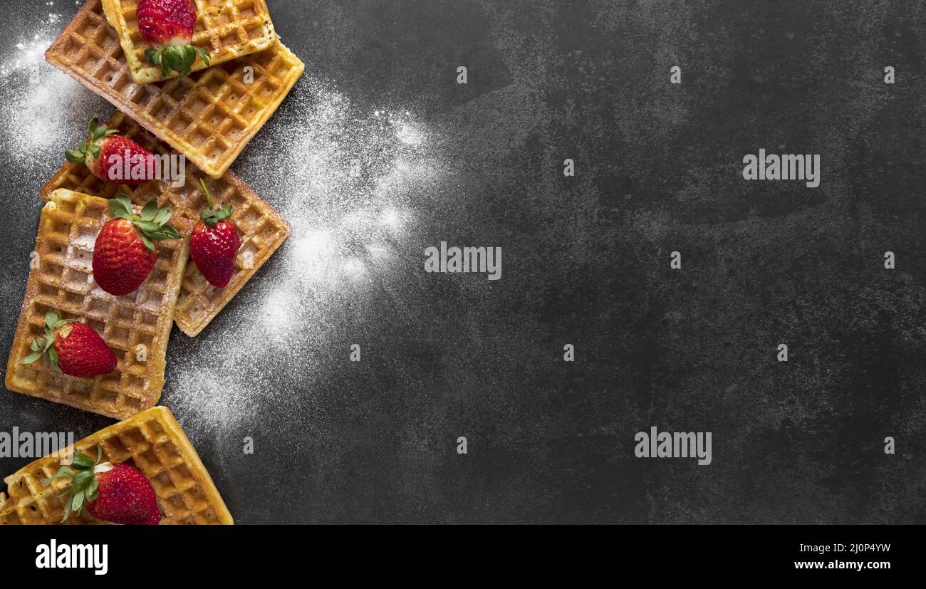 Top view waffles with powdered sugar strawberries. High quality and resolution beautiful photo concept Stock Photo