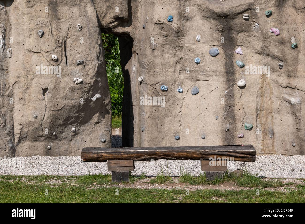 Climbing wall in urban park, manmade rock with holds and grips. Stock Photo