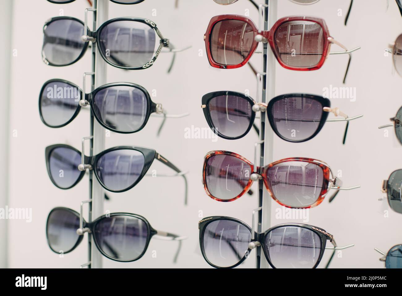 Glasses on the counter in the optics store. Eyeglasses goggles sunglasses on shop. Stock Photo