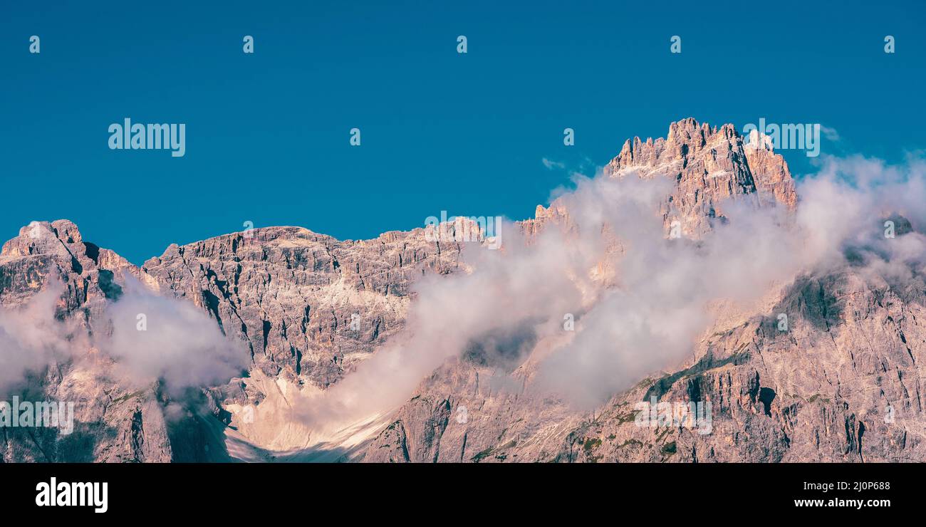 Clouds over mountain peaks in the Dolomites Stock Photo - Alamy