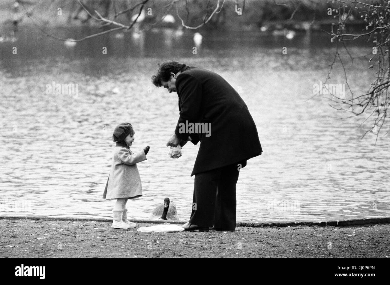 Chancellor of the Exchequer Nigel Lawson enjoys a pre-Budget walk with his family in St James's Park, London. He is pictured with his daughter Emily. 13th March 1984. Stock Photo