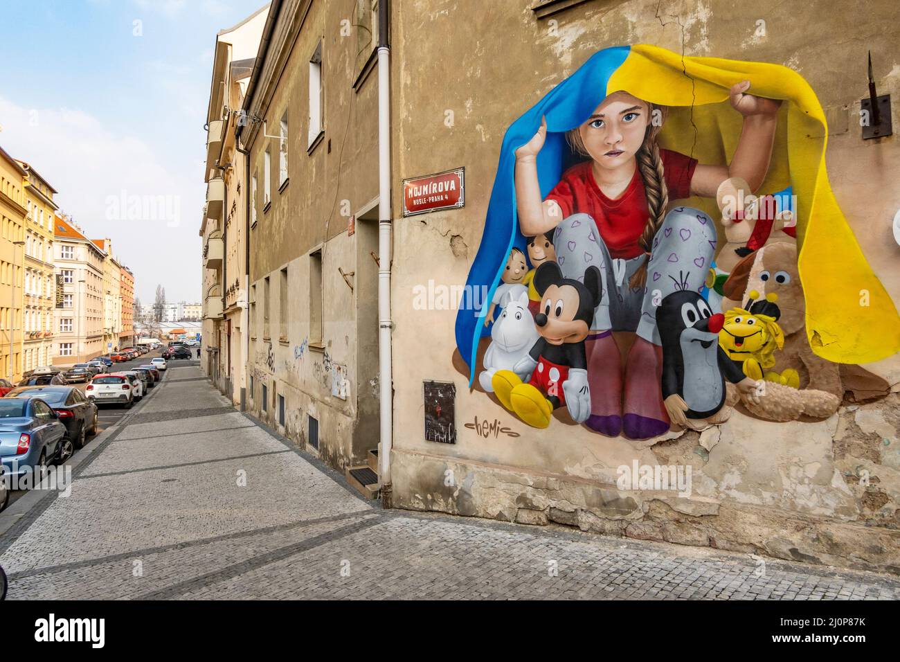 A girl taking shelter under a Ukrainian flag, mural art by ChemiS ...