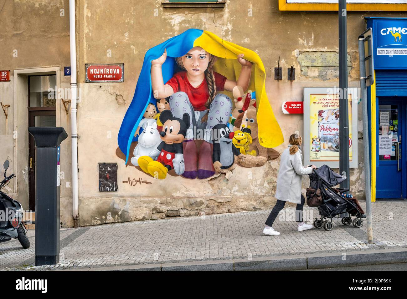 A girl taking shelter under a Ukrainian flag, mural art by ChemiS ...