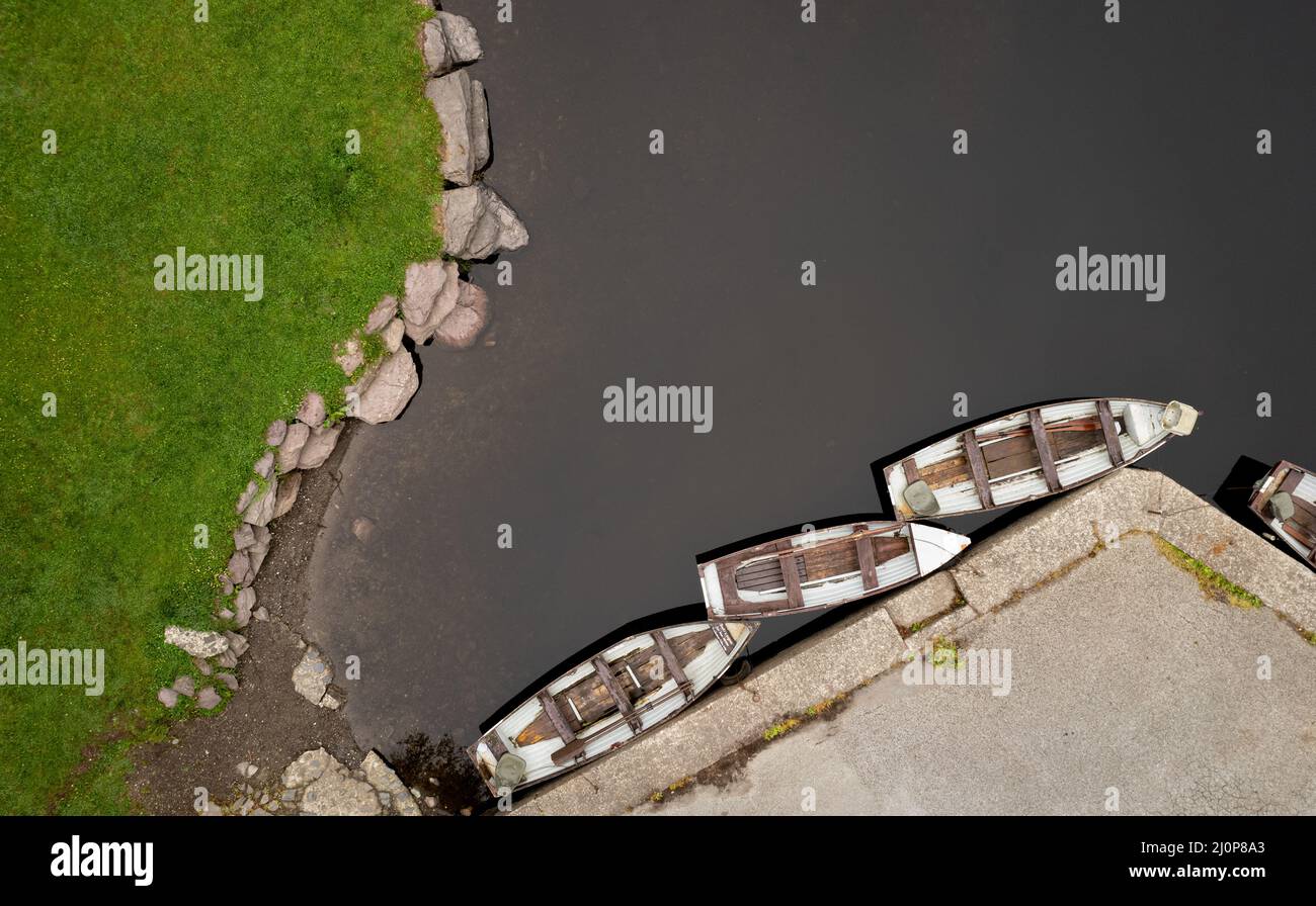 Drone aerial scenery of a river with boat moored on the river side. Keimeens Ireland County Stock Photo