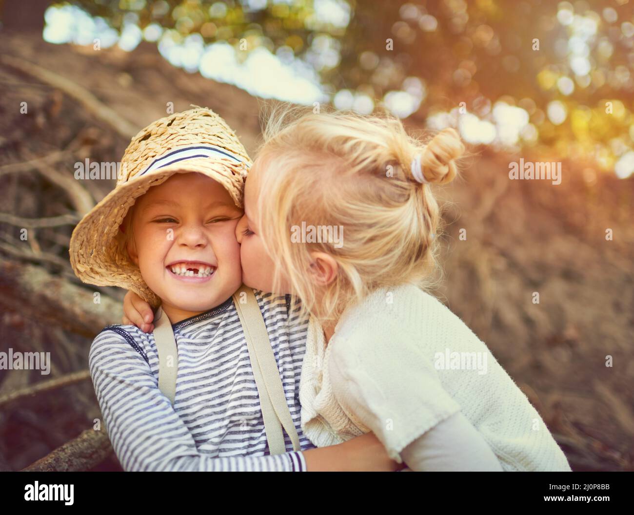 The bond between siblings is an unbreakable one. Shot of two little children playing together outdoors. Stock Photo