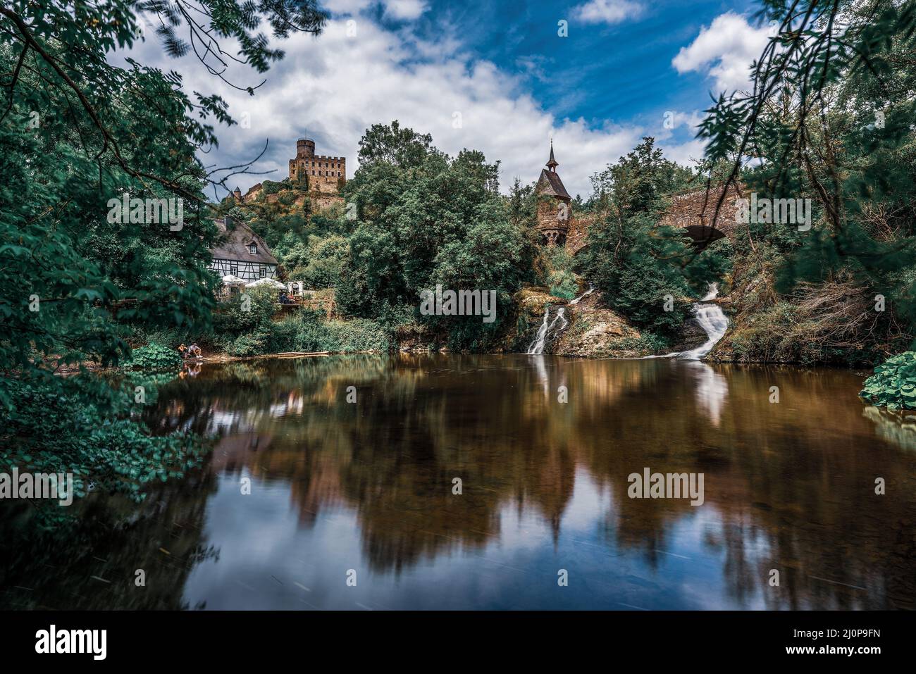 Pyrmonter Mühle at Elzbachfall with the castle in the background Stock