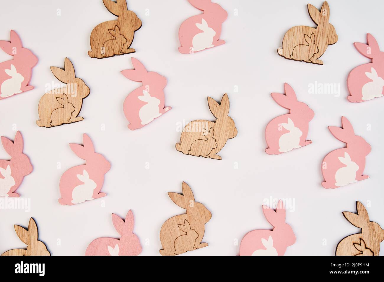 Pattern with wooden rabbit on white background, Happy Easter card Stock Photo