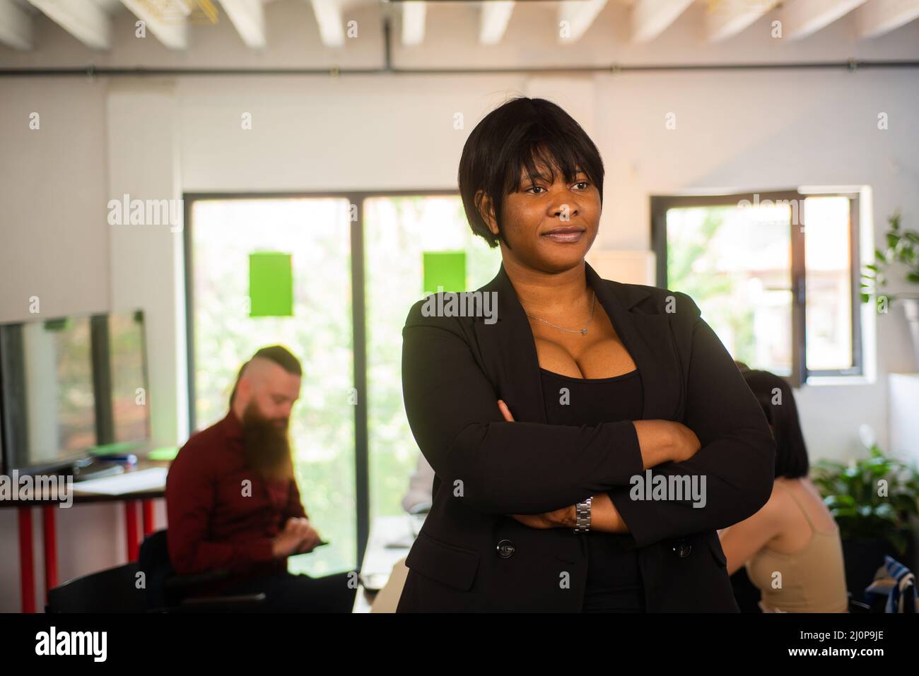 Beautiful african businesswoman is smiling at the camera while posing ...