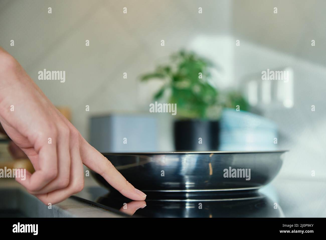 Steel frying pan in the kitchen on electric induction hob, Modern