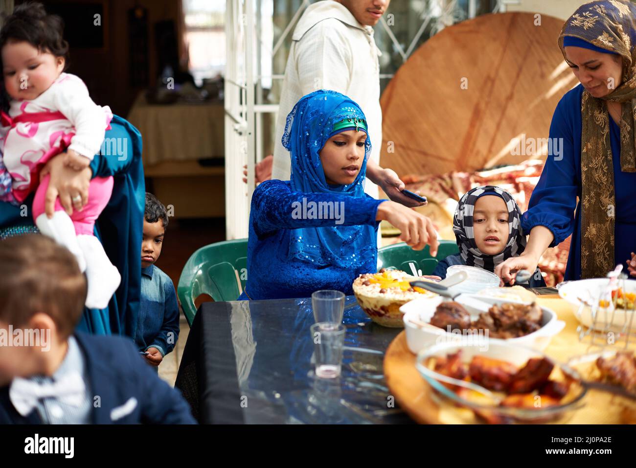 Food brings everyone together. Shot of a muslim family eating together. Stock Photo