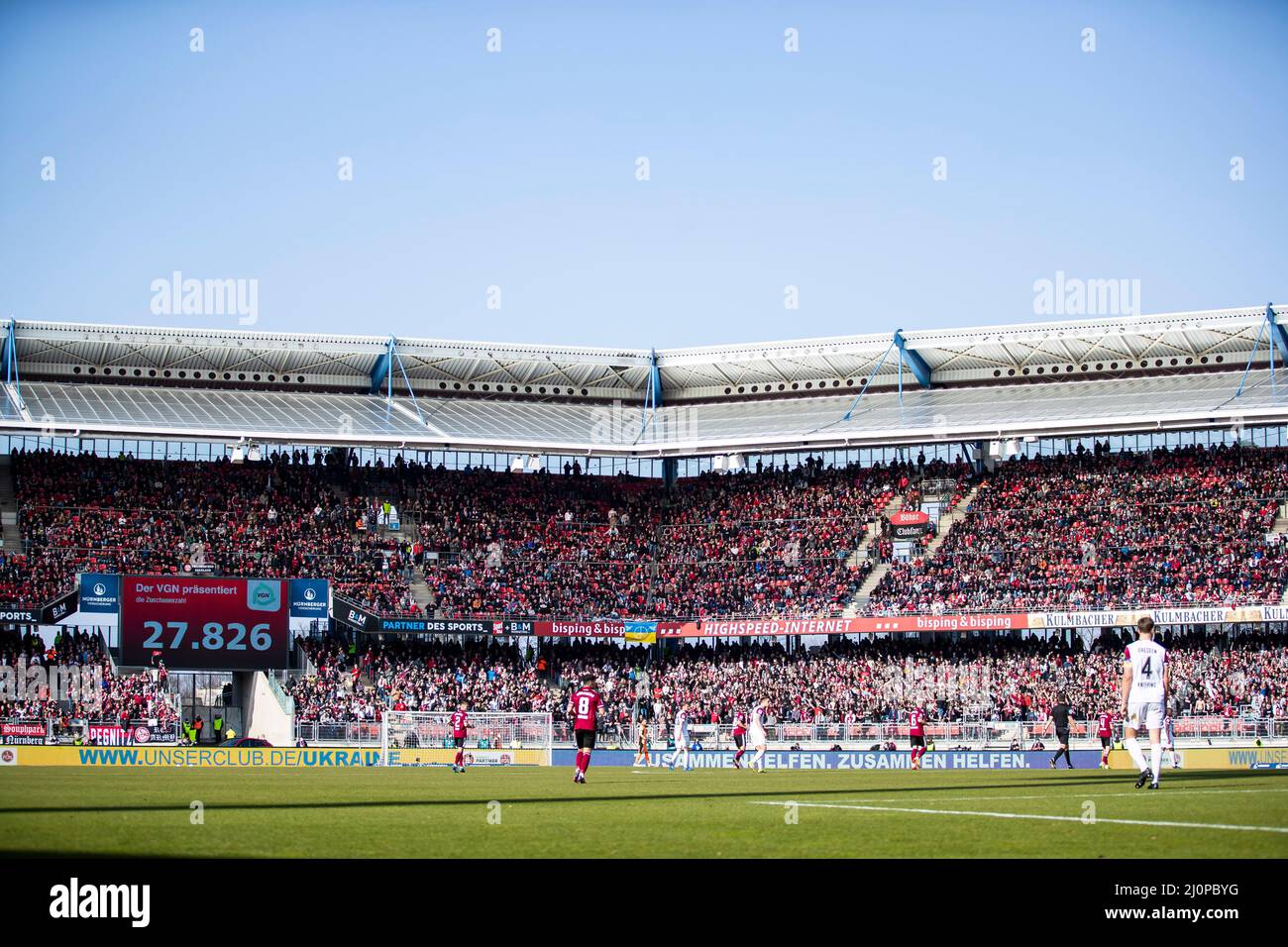 Nuremberg, Germany. 20th Mar, 2022. Soccer: 2. Bundesliga, 1. FC Nürnberg - Dynamo Dresden, 27. matchday, Max-Morlock-Stadion. Overview of Max Morlock Stadium during the match with spectators. The scoreboard shows the number of spectators 27,826 Credit: Tom Weller/dpa - IMPORTANT NOTE: In accordance with the requirements of the DFL Deutsche Fußball Liga and the DFB Deutscher Fußball-Bund, it is prohibited to use or have used photographs taken in the stadium and/or of the match in the form of sequence pictures and/or video-like photo series./dpa/Alamy Live News Stock Photo