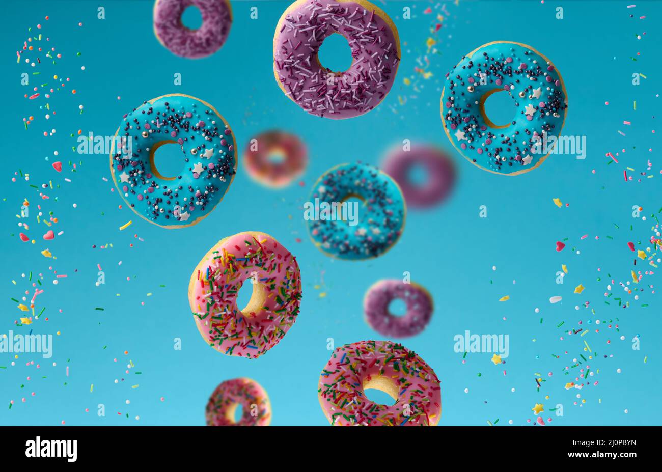 Sweet multicolored donuts levitate on a blue background, sugar ...
