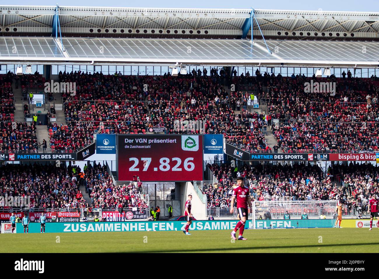 Nuremberg, Germany. 20th Mar, 2022. Soccer: 2. Bundesliga, 1. FC Nürnberg - Dynamo Dresden, 27. matchday, Max-Morlock-Stadion. Overview of Max Morlock Stadium during the match with spectators. The scoreboard shows the number of spectators 27,826 Credit: Tom Weller/dpa - IMPORTANT NOTE: In accordance with the requirements of the DFL Deutsche Fußball Liga and the DFB Deutscher Fußball-Bund, it is prohibited to use or have used photographs taken in the stadium and/or of the match in the form of sequence pictures and/or video-like photo series./dpa/Alamy Live News Stock Photo