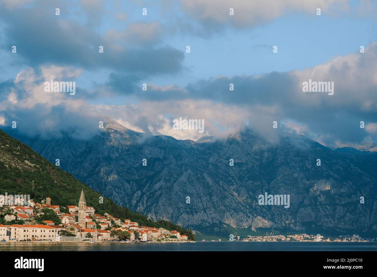 Perast coastline with old houses against a cloudy sky. Montenegro Stock Photo