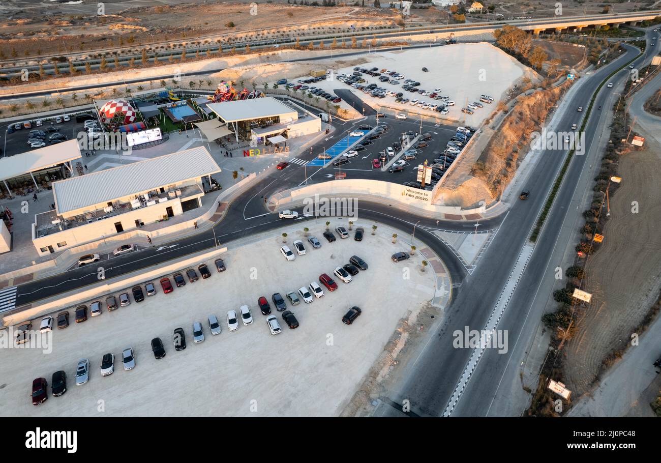 Aerial drone view of a modern designed motorway junction. Road transportation at shopping center. Stock Photo