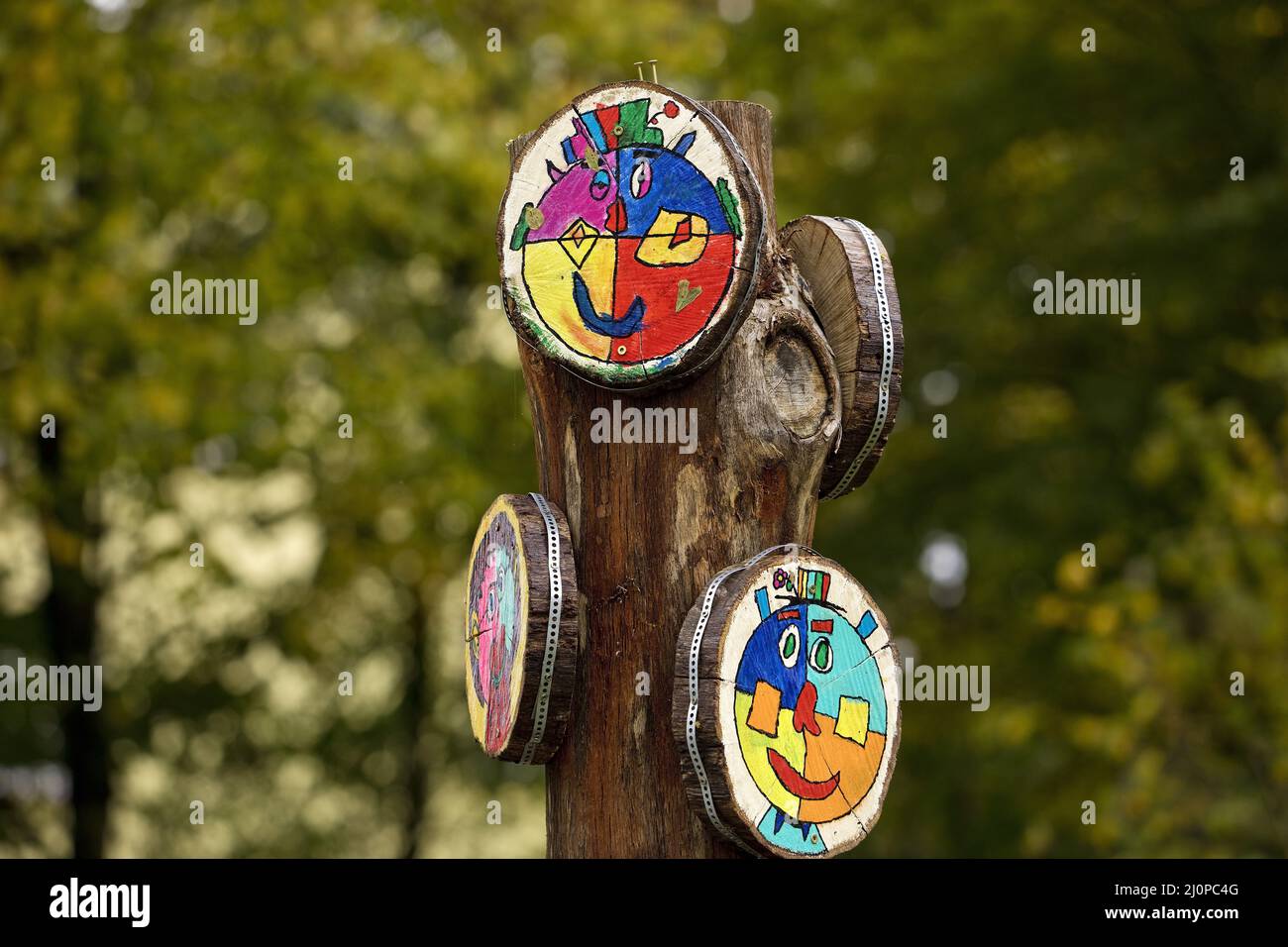 Work of art scrubbing stake tree discs, designed by children, art project Halver, Germany, Europe Stock Photo