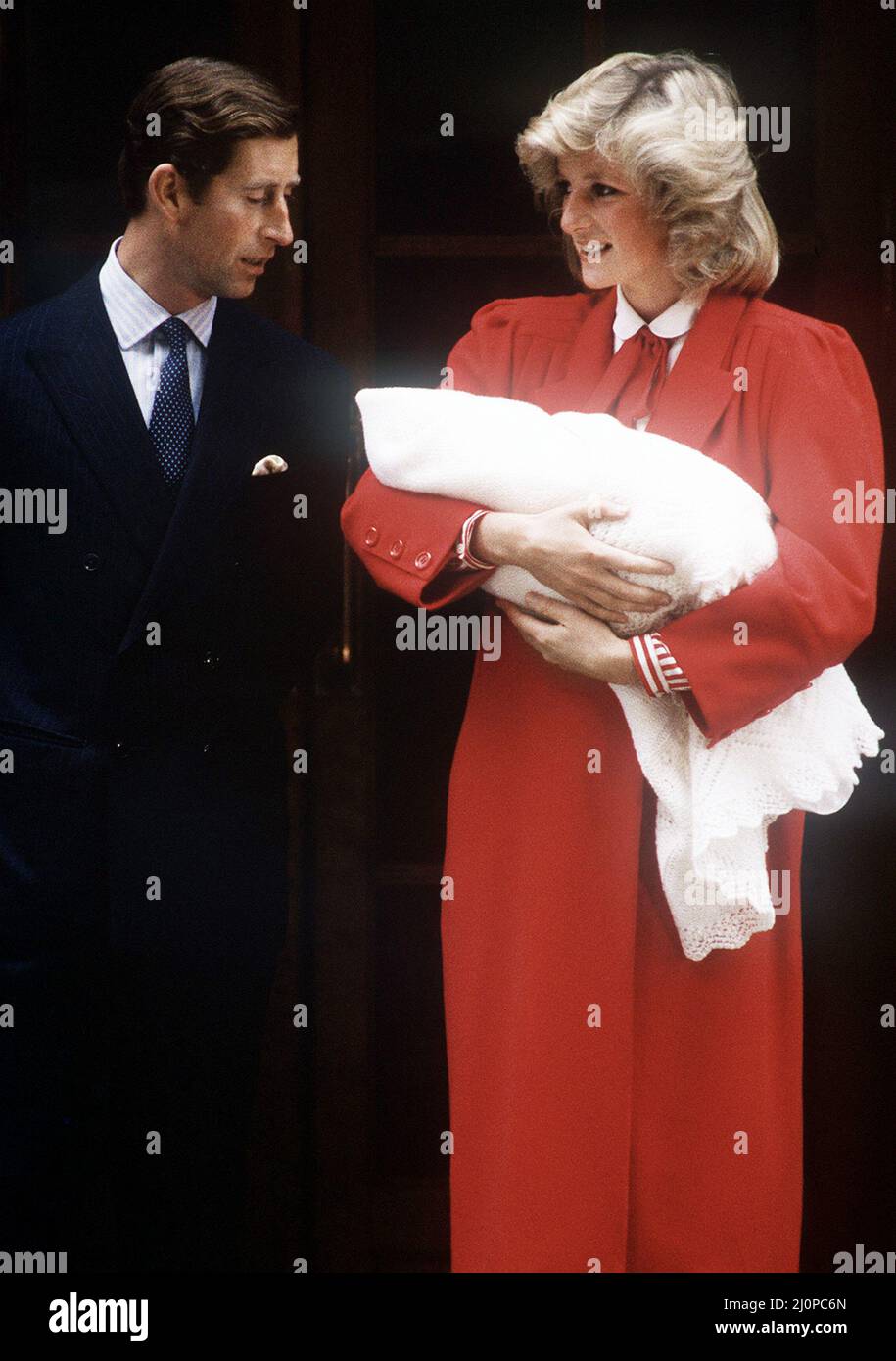 Princess Diana and Prince Charles leaving St Mary's Hospital, London with their newborn son, Prince Harry, 16th September 1984.  The Princess is wearing a red coat by Jan van Velden. Stock Photo