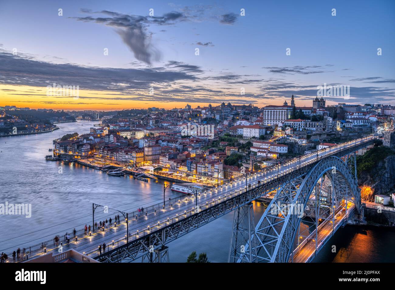 View of Porto with the famous iron bridge and the river Douro after sunset Stock Photo