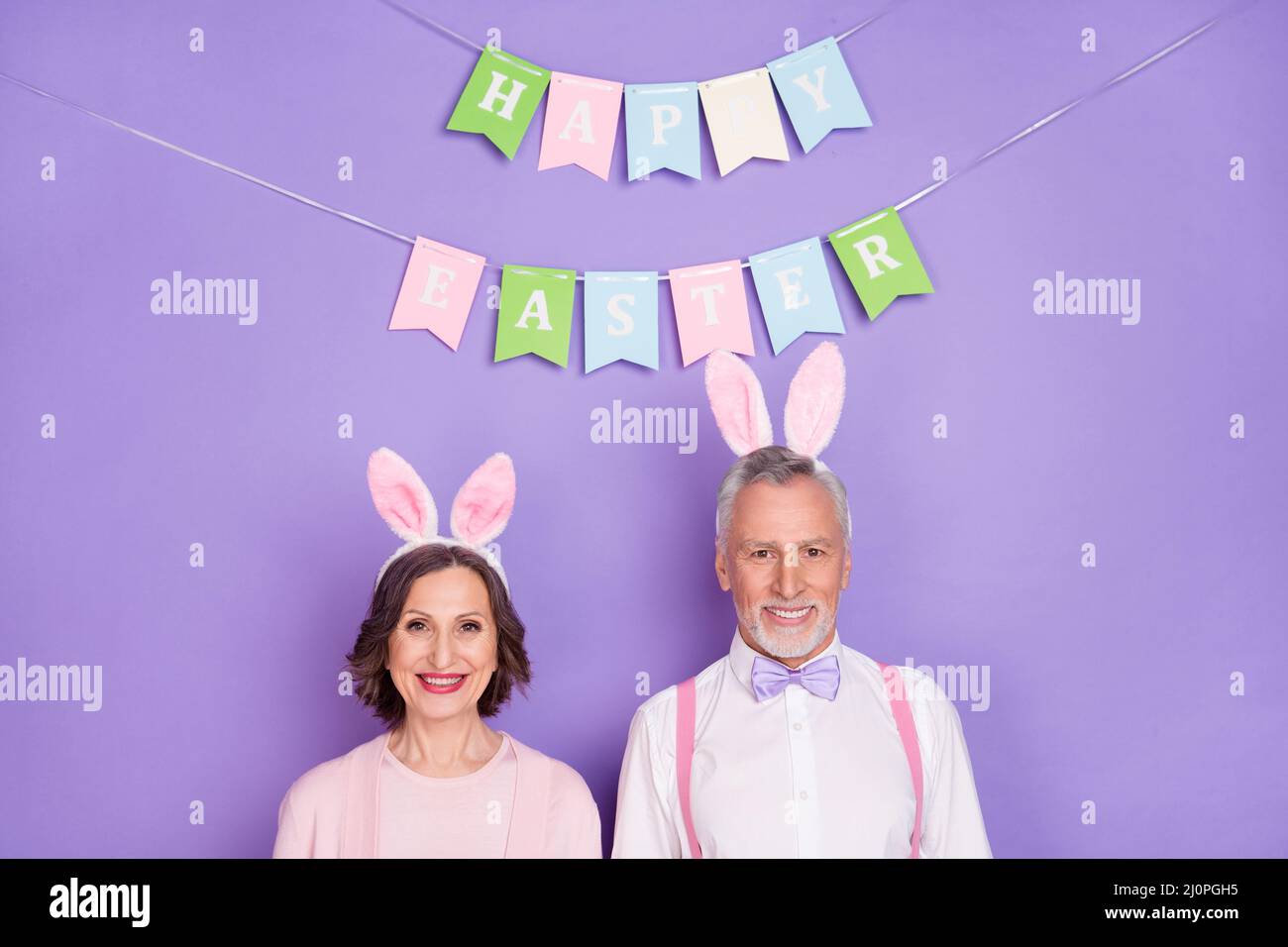 Portrait of positive cheerful two people toothy beaming smile look camera isolated on purple color background Stock Photo