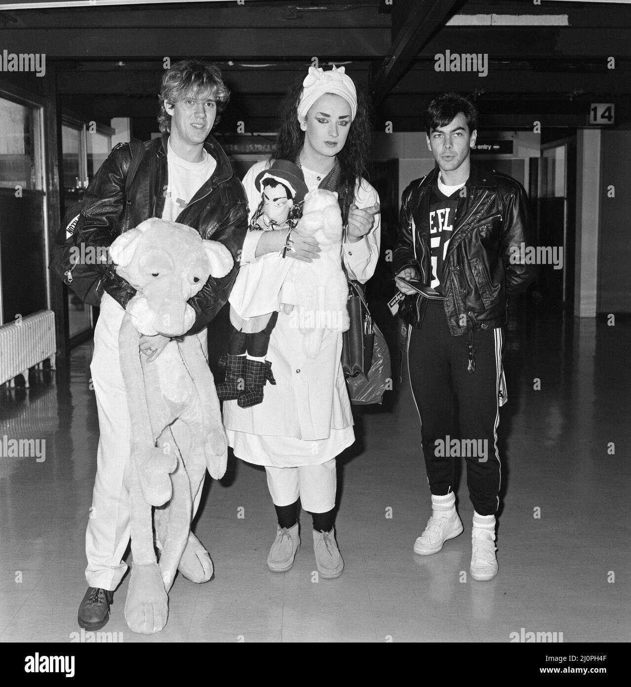 Pop group Culture Club arrive at Heathrow Airport from Madrid. Pictured, left to right, John Suede, Boy George and  Jon Moss. 5th November 1983. Stock Photo