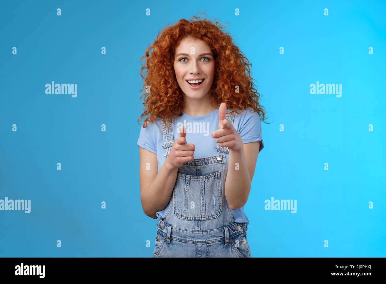 Gotcha. Cool sassy good-looking redhead curly woman pointing camera finger pistols cheeky introduction smiling excited having fu Stock Photo