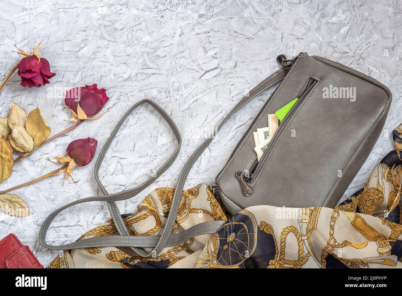 A small women's clutch bag next to other accessories. Money and a card are  visible from an open pocket. Top view, flat position, copy space Stock  Photo - Alamy